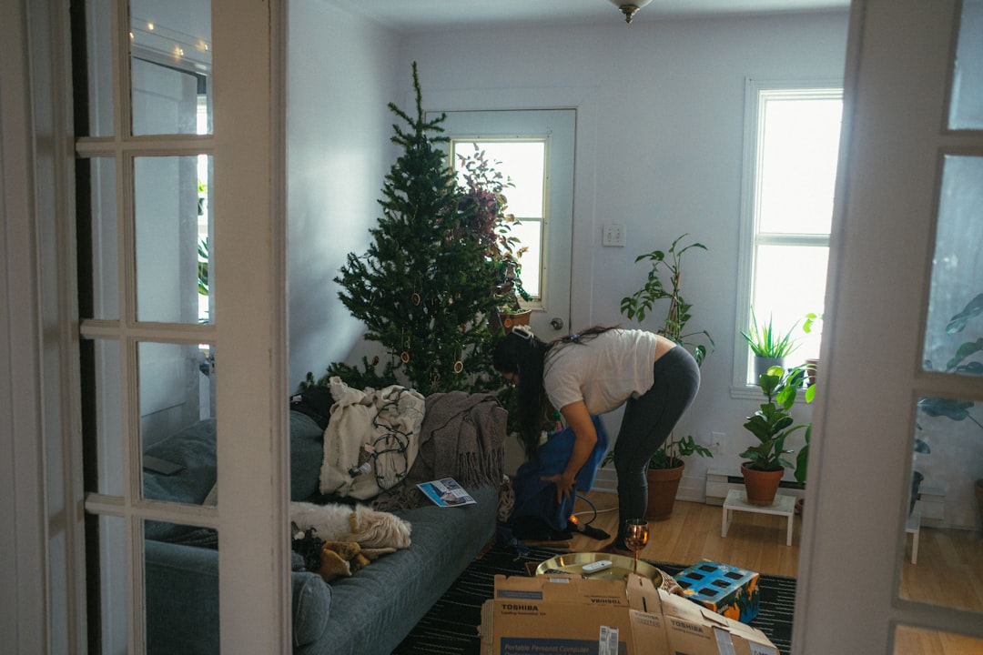 about-us-01 a-woman-bending-over-a-couch-in-a-living-room-lkwbqogs2c0